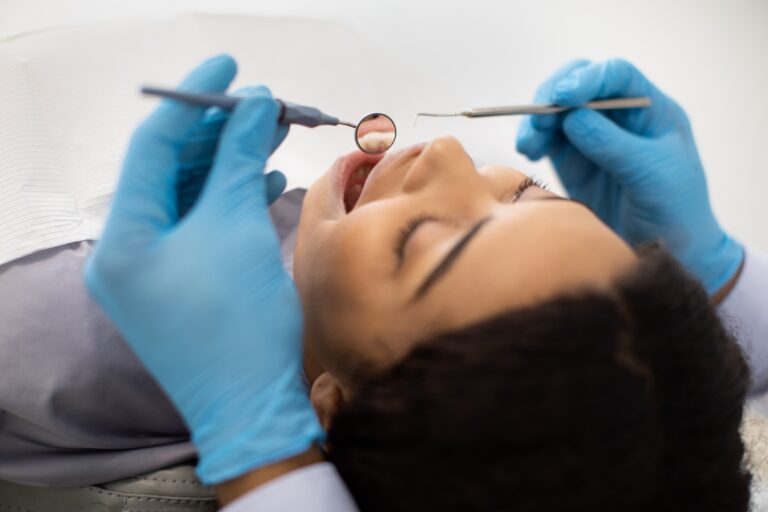 Dental hygienist performing a professional teeth cleaning at Twiss Dental in Highlands Ranch